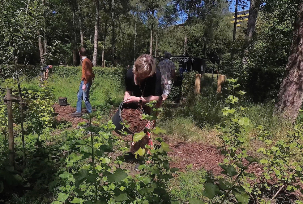 Foto van wethouder Laura Hoogstraten die tijdens de opening aan het werk is in de Voedselbosrand